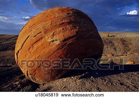 Stock Photo - Large red boulder in desert valley Red Rock Coulee Alberta. Fotosearch
