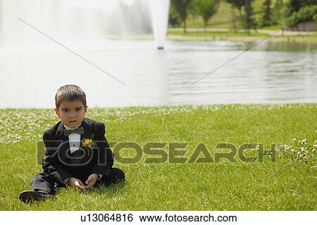 Stock Photograph - Little boy sits and waits. Fotosearch