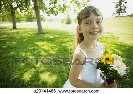 Stock Photograph - Little girl in a park. Fotosearch