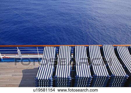 Lounging chairs in a stack View Large Photo Image Picture - Lounging chairs in a stack. Fotosearch