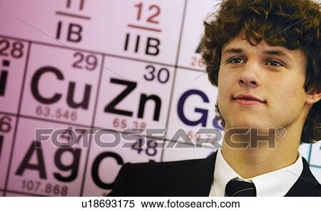 Stock Photography - Male teenage student in front of chart. Fotosearch