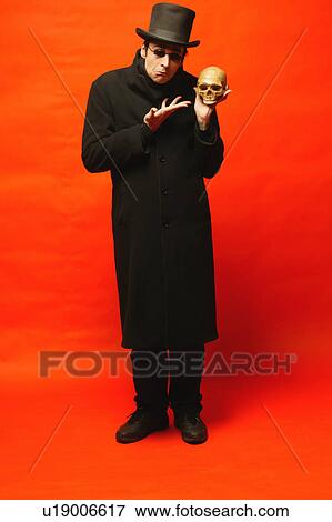 Man displays skull View Large Photo Image Stock Photo - Man displays skull. Fotosearch