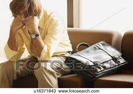 Stock Image - Man dozes in airport. Fotosearch
