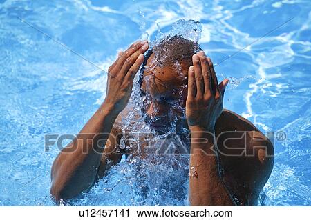 Stock Image - Man in swimming pool. Fotosearch