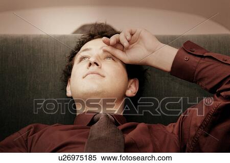 Man laying back on sofa View Large Photo Image Stock Photography - Man laying back on sofa. Fotosearch