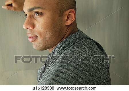 Stock Photo - Man leaning against a wall. Fotosearch