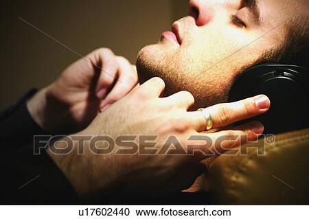 Man listens to music View Large Photo Image Stock Image - Man listens to music. Fotosearch