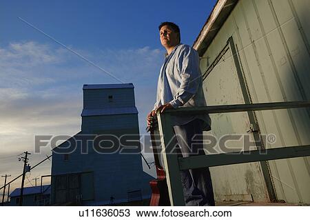 Man looks out at day's work View Large Photo Image Stock Image - Man looks out at day's work. Fotosearch