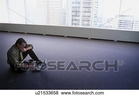 Man on floor of empty office View Large Photo Image Stock Photo - Man on floor of empty office. Fotosearch