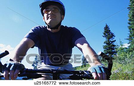 Stock Image - Man on mountain bike. Fotosearch