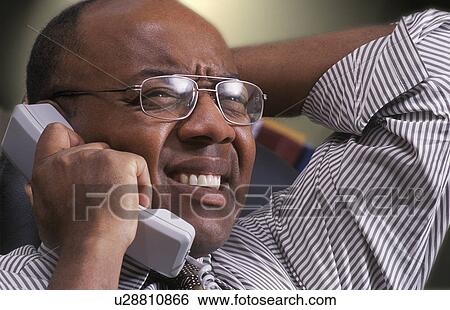 Stock Photograph - Man on telephone. Fotosearch