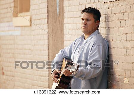 Stock Image - Man plays guitar. Fotosearch