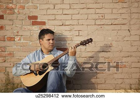 Man plays guitar View Large Photo Image Stock Image - Man plays guitar. Fotosearch