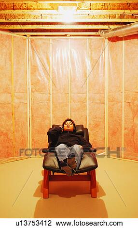 Man relaxes in unfinished room View Large Photo Image Stock Image - Man relaxes in unfinished room. Fotosearch