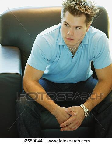Stock Image - Man relaxes on a chair. Fotosearch