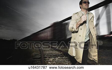 Stock Photo - Man runs alongside a train. Fotosearch