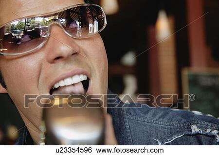 Stock Photograph - Man singing into a microphone. Fotosearch