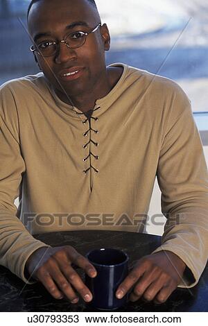 Man sitting at table View Large Photo Image Stock Image - Man sitting at table. Fotosearch