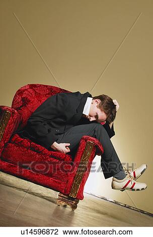 Man sitting on a chair View Large Photo Image Stock Image - Man sitting on a chair. Fotosearch