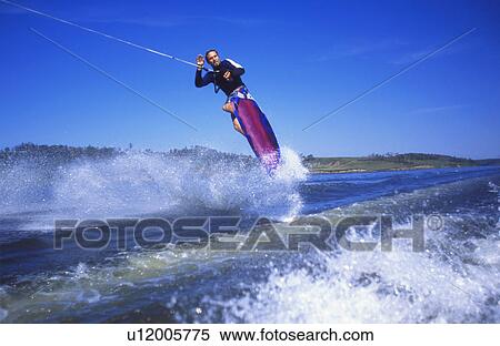 Man wakeboarding on Coal Lake Alberta Canada View Large Photo Image Stock Photography - Man wakeboarding on Coal Lake Alberta Canada. Fotosearch