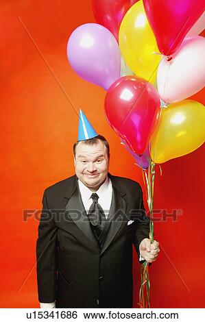 Stock Photograph - Man with balloons. Fotosearch