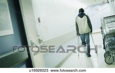 Man with crutches View Large Photo Image Stock Image - Man with crutches. Fotosearch