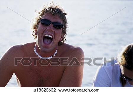 Man with shell necklace at lake View Large Photo Image Stock Image - Man with shell necklace at lake. Fotosearch