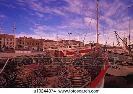 Moored fishing boat with crab traps on foredeck View Large Photo Image Picture - Moored fishing boat with crab traps on foredeck. Fotosearch