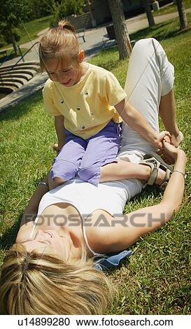 Mother and daughter play in the park View Large Photo Image Stock Image - Mother and daughter play in the park. Fotosearch