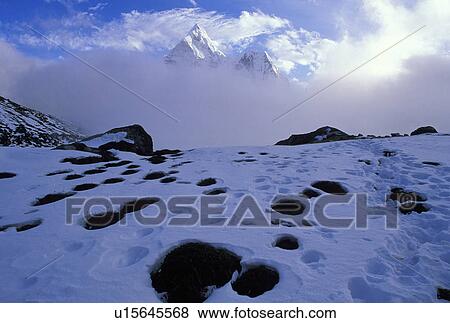 Stock Photo - Mountain peak cover by a mist of cloud. Fotosearch