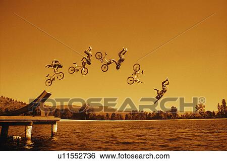 Multiple exposure of cyclist going off jump into water in brown tones View Large Photo Image Stock Photograph - Multiple exposure of cyclist going off jump into water in brown tones. Fotosearch