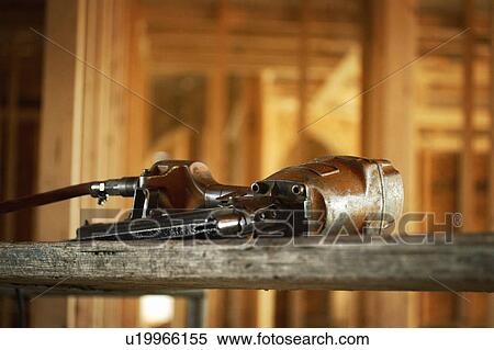 Stock Photography - Nail gun inside house under construction. Fotosearch