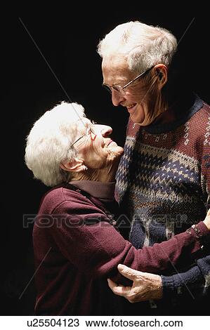 Stock Image - Older couple look at each other. Fotosearch