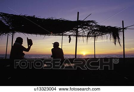 On the beach at sunset View Large Photo Image Picture - On the beach at sunset. Fotosearch