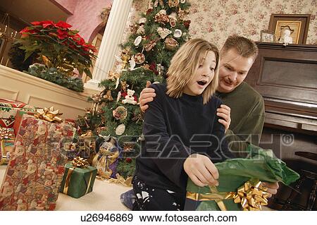 Stock Photo - Opening a present. Fotosearch
