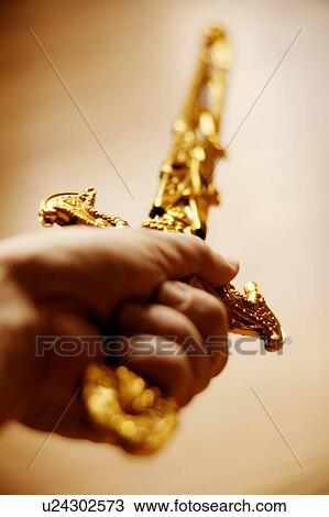 Ornamental sword held aloft View Large Photo Image Stock Image - Ornamental sword held aloft. Fotosearch