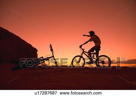 Person on bike pointing View Large Photo Image Stock Photo - Person on bike pointing. Fotosearch