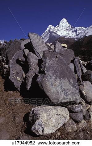 Stock Image - Pile of boulders and rocks in front of mountain. Fotosearch