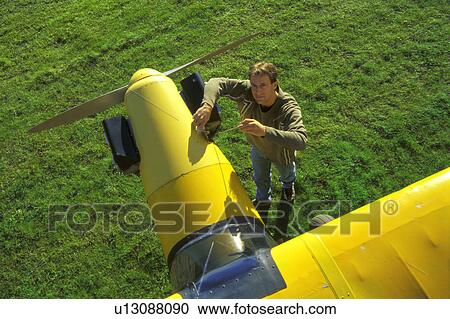 Pilot with his airplane View Large Photo Image Stock Image - Pilot with his airplane. Fotosearch