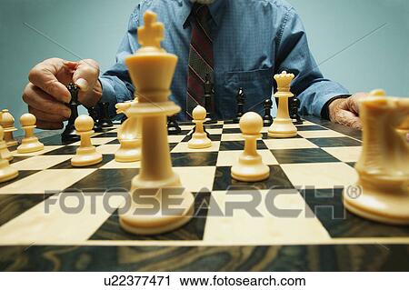 Stock Image - Playing a game of chess. Fotosearch
