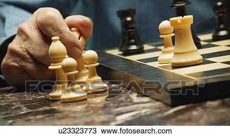 Stock Image - Playing a game of chess. Fotosearch