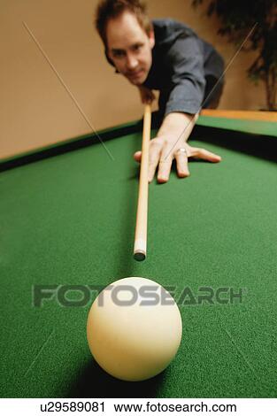 Stock Image - Playing a game of pool. Fotosearch