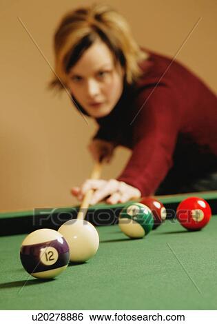 Stock Photograph - Playing a game of pool. Fotosearch