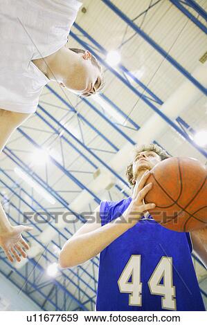 Stock Photo - Playing basketball. Fotosearch