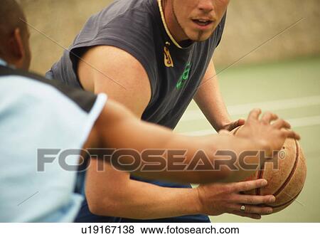 Stock Photo - Playing basketball. Fotosearch