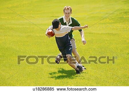 Stock Photography - Playing football. Fotosearch
