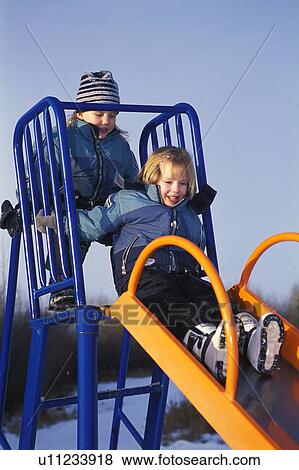 Playing on a slide View Large Photo Image Stock Photo - Playing on a slide. Fotosearch