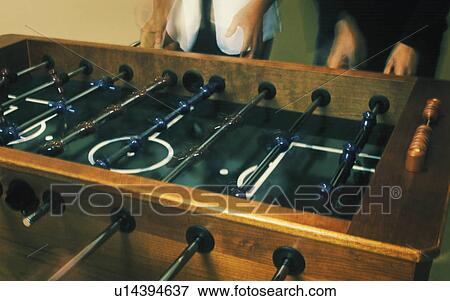 Stock Photo - Playing table football. Fotosearch