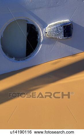 Stock Photograph - Porthole and marker light on boat. Fotosearch