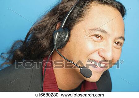 Stock Image - Portrait of a man with headset. Fotosearch